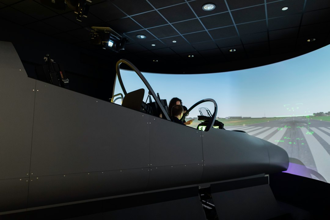 Aerospace engineer and pilots in flight simulator